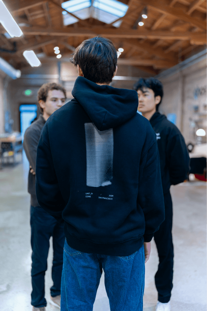 Zain wearing a Ghost hoodie in the factory